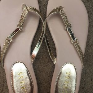 Guess gold flip flops
